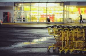 Supermarket carpark at night with trolleys lined up